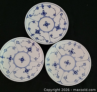 Front view of three matching Royal Copenhagen blue fluted plates