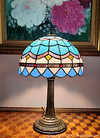 Full view of lamp lit showing shade colors and base