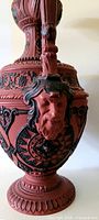 Profile view of ewer showing satyr mask and relief detail