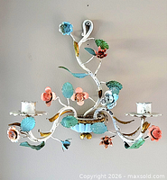 full view of floral toleware wall sconce showing two candle holders and overall design