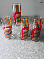 four of six striped glasses showing design and clarity