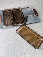 Tray with three inserts, one insert removed showing recess