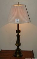Brass Stiffel lamp with shade illuminated, front view