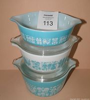 Stacked view of three Butterprint casseroles showing pattern and lids