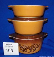 Three stacked Old Orchard casseroles showing exterior colors and pattern