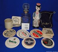 Group view of coasters, Crown Royal bag, ceramic decanter, glass decanter, mug
