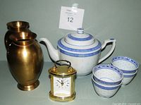 Entire lot: porcelain tea set pieces, two brass vases and Bulova brass carriage clock