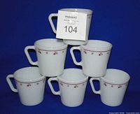 Front view of six stacked Pyrex Burgundy Rose mugs