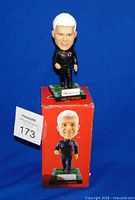Front view of Wally Buono bobblehead on top of original red illustrated box