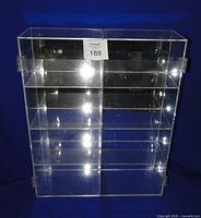 Front view of clear plexiglass display case showing eight compartments