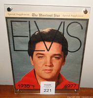 Front view of framed supplement showing Elvis portrait cover, bolts at corners
