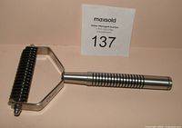 Full view of OSTER grooming rake handle left, head right