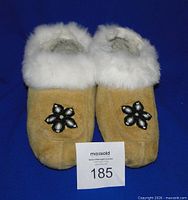 Top view of moccasins showing beadwork and fur trim