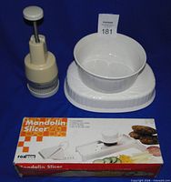 Round dish stacked on oval dish with chopper and slicer box visible