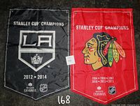 Front sides of both banners: LA Kings (black) and Chicago Blackhawks (red)