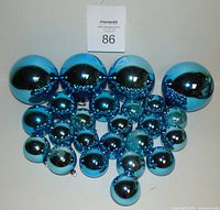 Group shot of all 24 turquoise mercury glass ornaments in three sizes