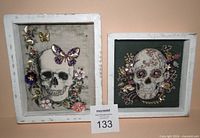 Front view of both framed skull artworks