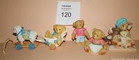 Front view showing all three Cherished Teddies figurines with footstool component