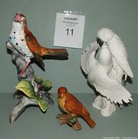 Front view of all three figurines showing relative sizes and finishes