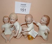 All four porcelain baby dolls grouped together