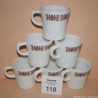 Six Anchor Hocking milk glass mugs stacked in pyramid showing pattern