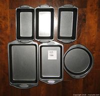 All six Wilton dark gray non-stick pans laid out