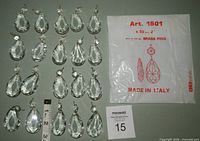 Twenty crystal prisms with ruler for scale and original packaging shown