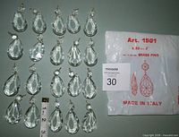 Array of 20 assembled teardrop prisms with ruler for scale