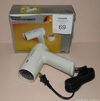 Hairdryer with cord beside original box