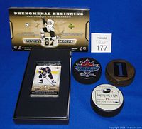 Boxed Sidney Crosby card set with three pucks displayed