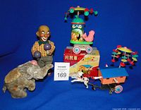 group shot of all four wind-up toys with box