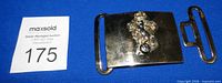 Front view of brass belt buckle and separate slide clasp