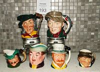 Front view of six porcelain character jugs