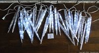 Both 11-foot icicle light strands illuminated on floor