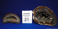 Large and small geodes side by side with lot card