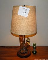 Front view of lamp with shade and miniature lantern beside it