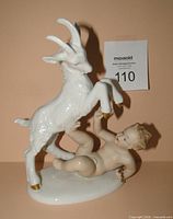 Front view of Wallendorf figurine showing putto with goat and gold hooves