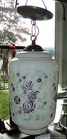 Full pendant showing white glass floral globe and metal canopy