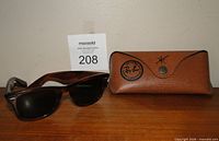 Sunglasses with case on wood surface