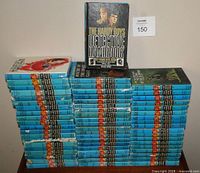 All 61 Hardy Boys books stacked, Detective Handbook displayed upright