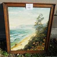 Front view of framed coastal oil painting
