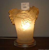 Lamp illuminated showing eagle relief and base