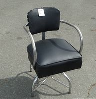 Front view of black vinyl industrial chair with chrome frame