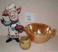 Front view of chef figurine, batter bowl, wooden apple