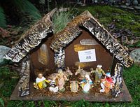 Front view of crèche with ten figures displayed