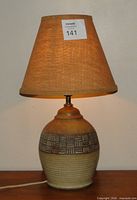 Full view of pottery lamp with burlap shade