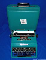 Typewriter in front of open case