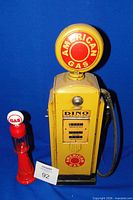 Front view of tin pump and glass bottle