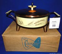Casserole assembled in cradle with lid on box