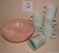 Full lot showing pink divided bowl, six milk glass mugs, stack of pastel coasters in caddy